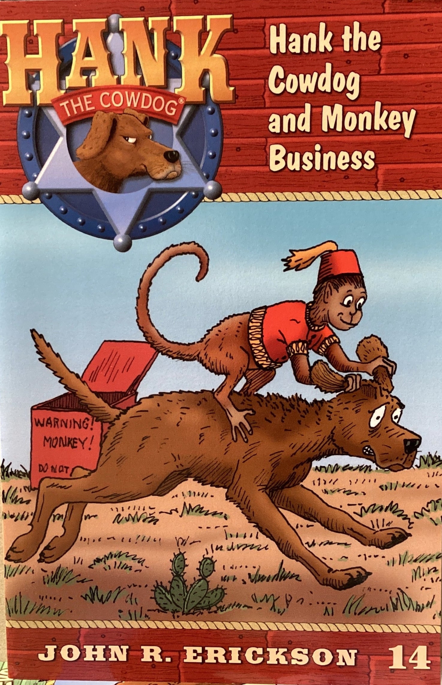 Book cover of 'Hank the Cowdog and Monkey Business' by John R. Erickson on a textured surface.