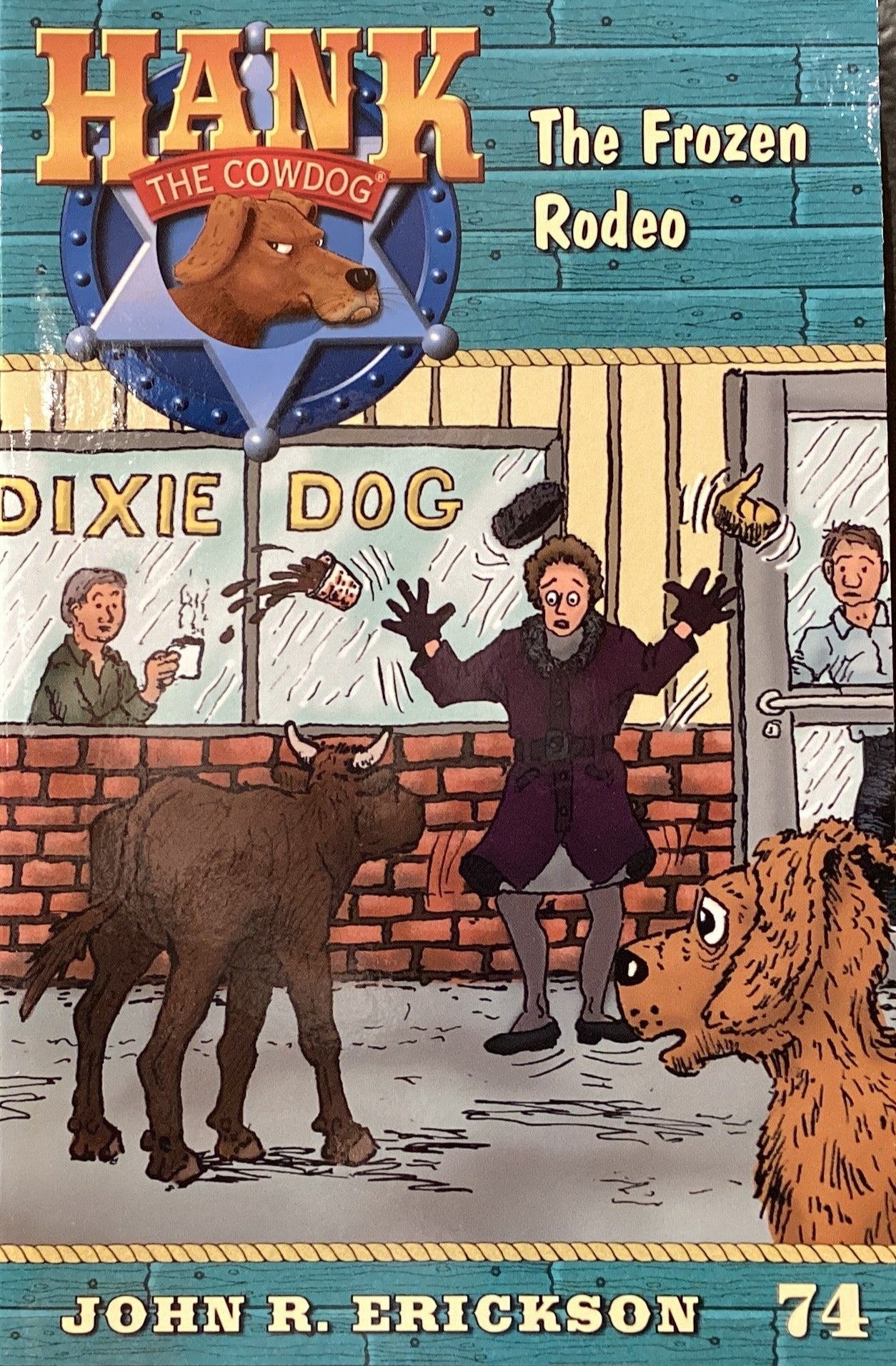 Book titled 'Hank the Cowdog: The Frozen Rodeo' by John R. Erickson on a surface with a dark gray wall background.