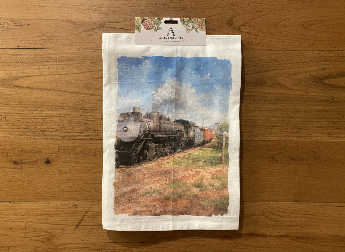Tea towel with a train design hanging on a gray wall