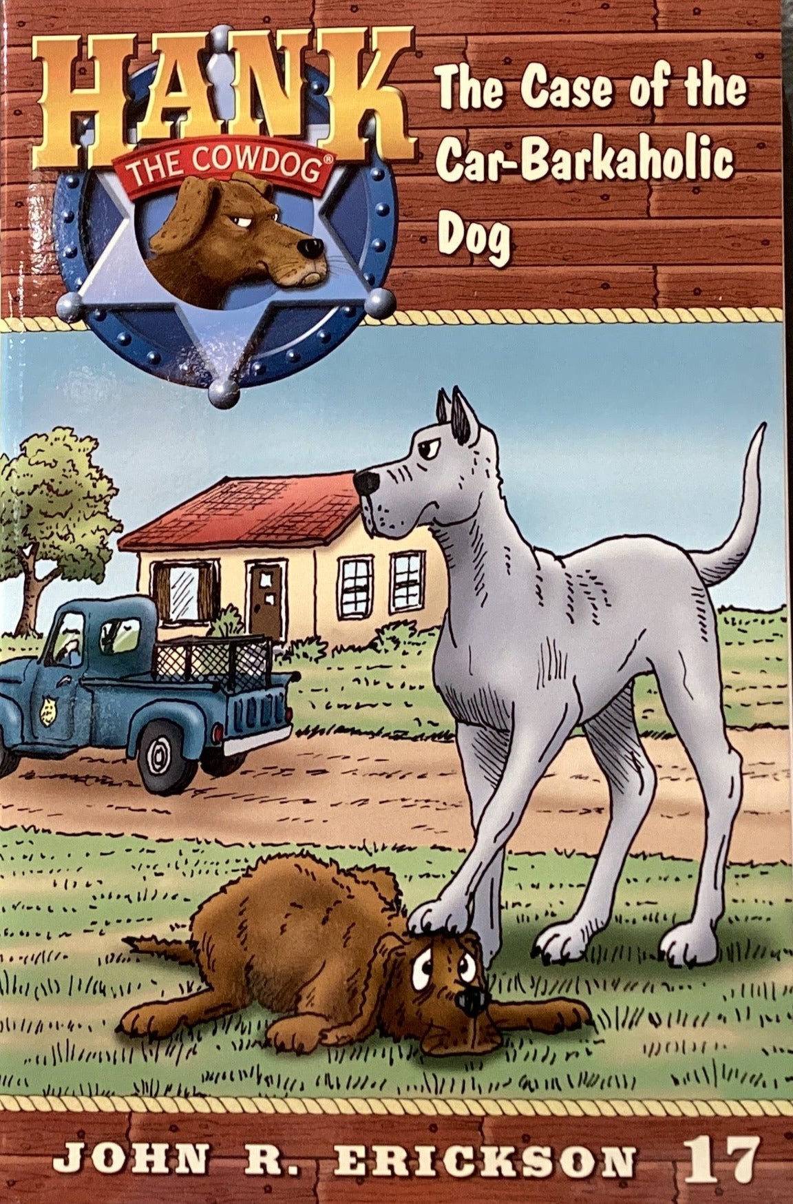 Book titled 'Hank: The Case of the Car-Barkhole Dog' by John R. Erickson on a shelf.