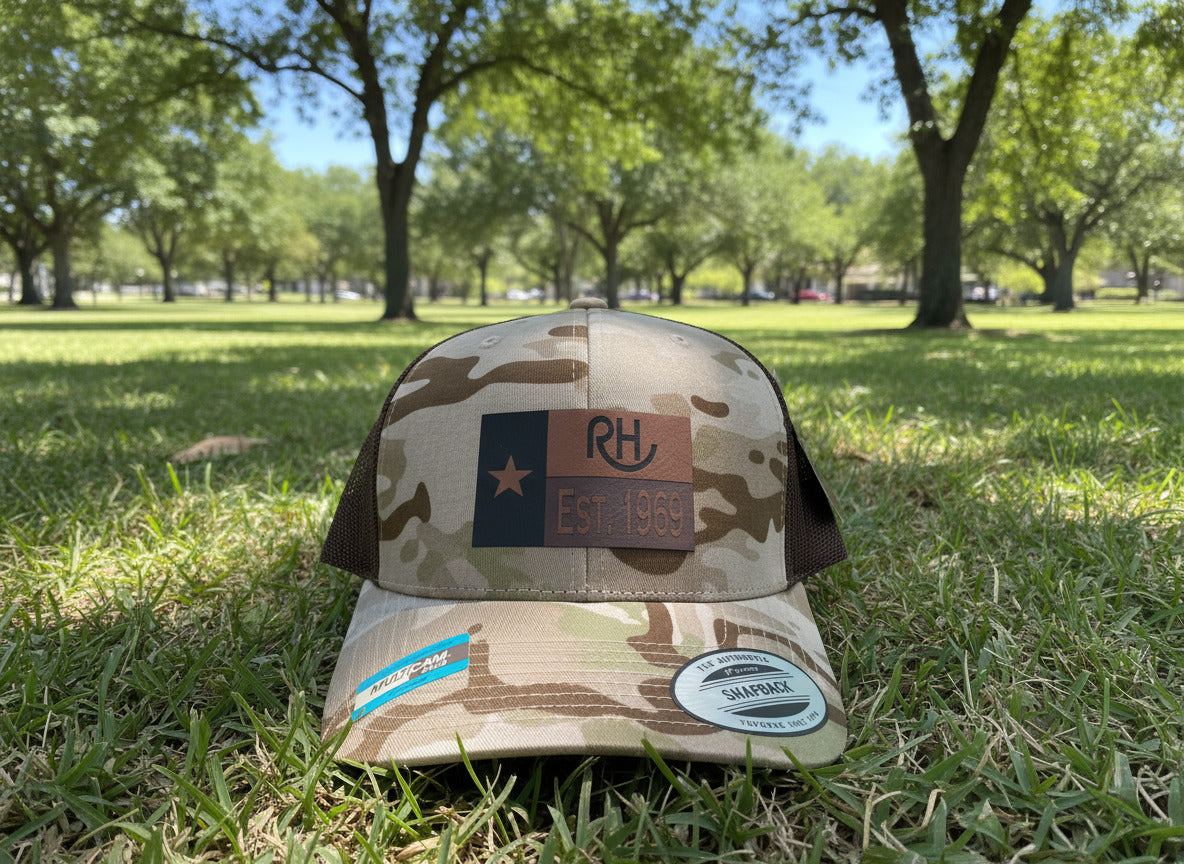 Camouflage trucker hat with a logo and text on a neutral background