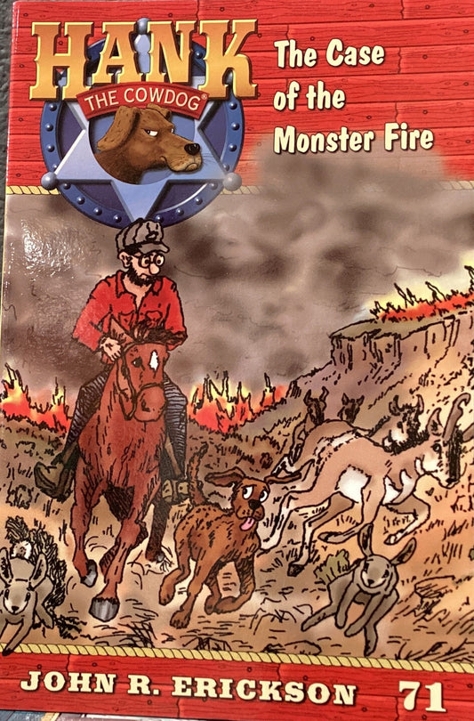 Book titled 'Hank the Cowdog: The Case of the Monster Fire' by John R. Erickson on a gray surface.