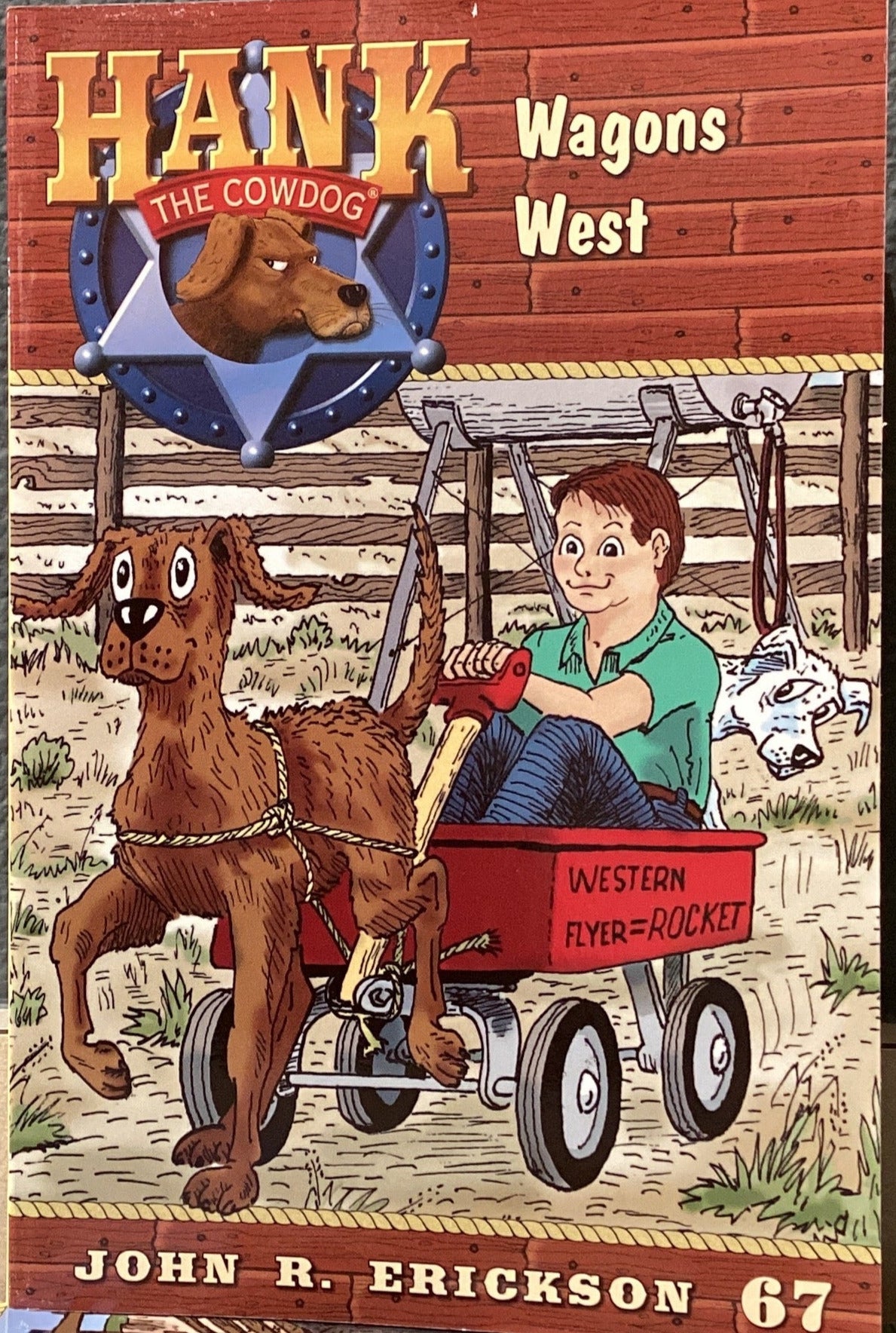 Book titled 'Hank Wagon West' by John R. Erickson on a table with a dark gray wall background.