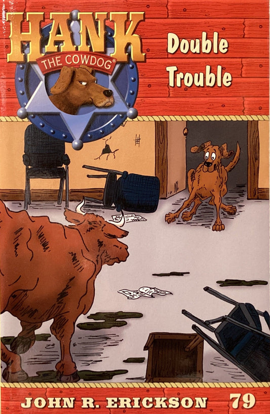 Book titled 'Hank the Cowdog: Double Trouble' by John R. Erickson on a gray floor.