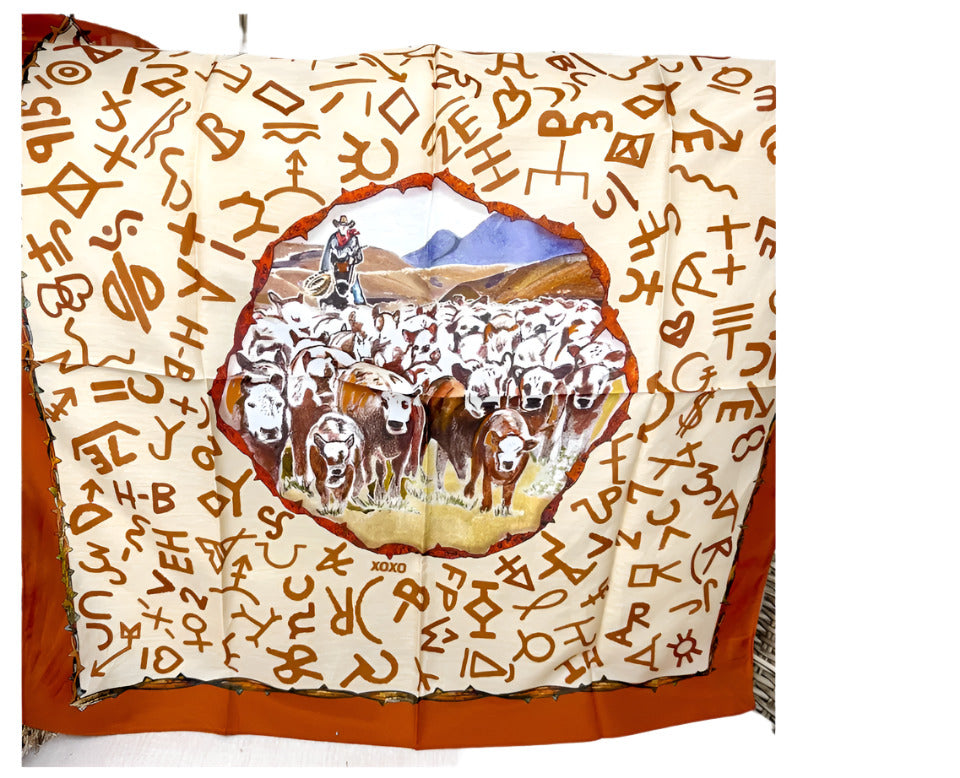 Decorative blanket with a central illustration of people and animals, surrounded by abstract symbols on a white background.