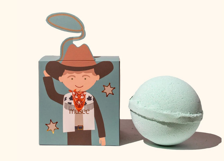 Bath bomb with a cowboy-themed packaging on a white background