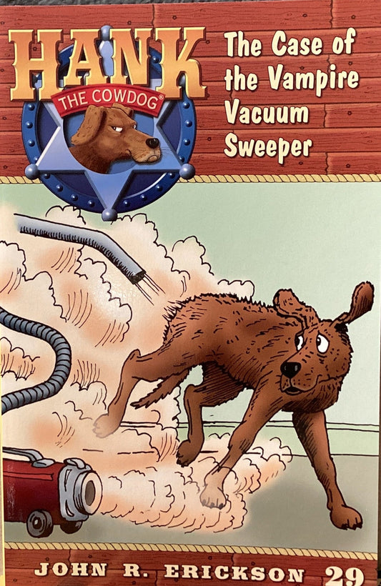 Book titled 'Hank the Cowdog: The Case of the Vampire Vacuum Sweeper' by John R. Erickson on a gray surface.