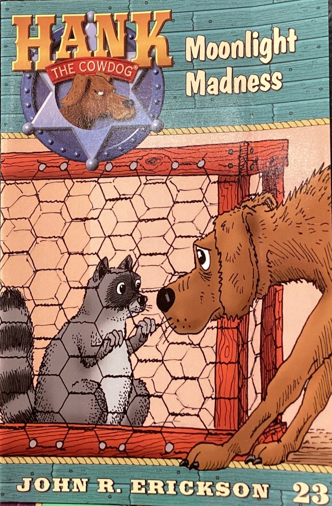 Children's book titled 'Moonlight Madness' by John R. Erickson on a dark surface.