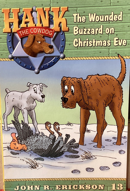 Book titled 'Hank the Cowdog: The Wounded Buzzard on Christmas Eve' by John R. Erickson on a gray surface.