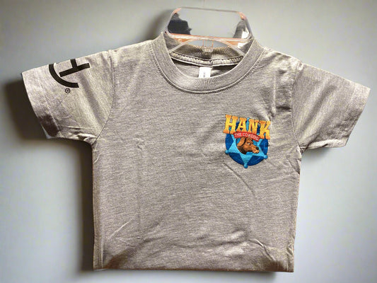 Gray t-shirt with a colorful graphic and text on a wooden hanger against a gray wall.