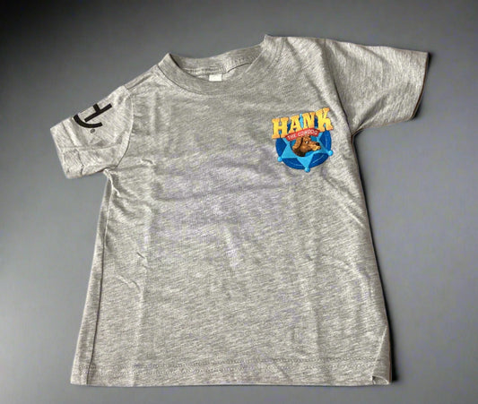 Gray t-shirt with a colorful graphic on a beige surface