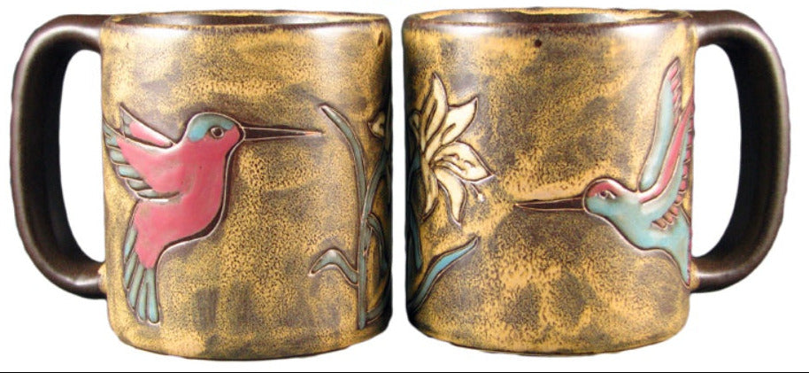 Two bronze-colored mugs with hummingbird and flower designs on a white background.