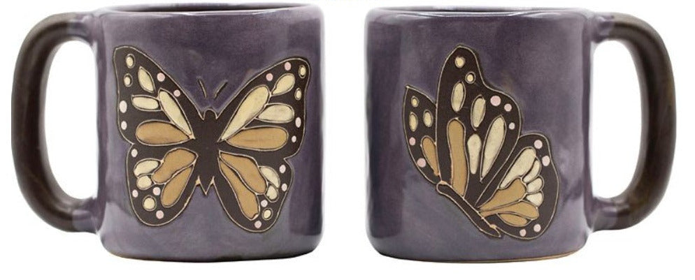 Two purple mugs with butterfly designs on a white background