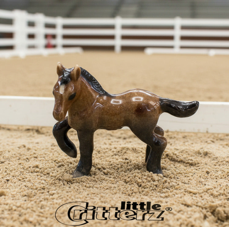 Small horse figurine with 'little Critterz' logo on a white background
