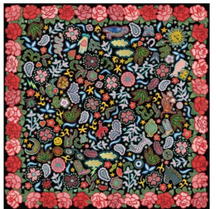 Colorful floral and nature-themed quilt on a white background