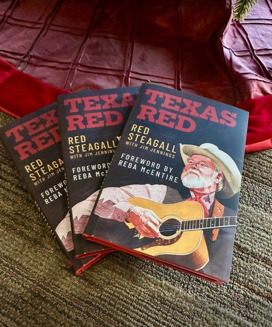 Three books titled 'Texas Red' by Red Steagall on a textured surface.