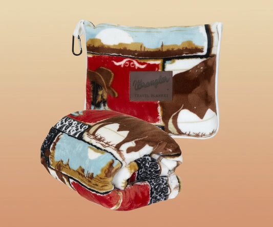 Travel blanket with cowboy design and Wrangler branding on a white background